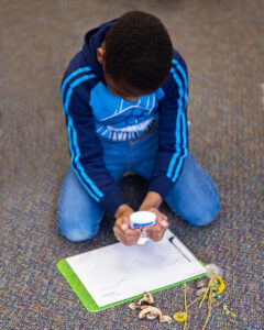 child working on collage